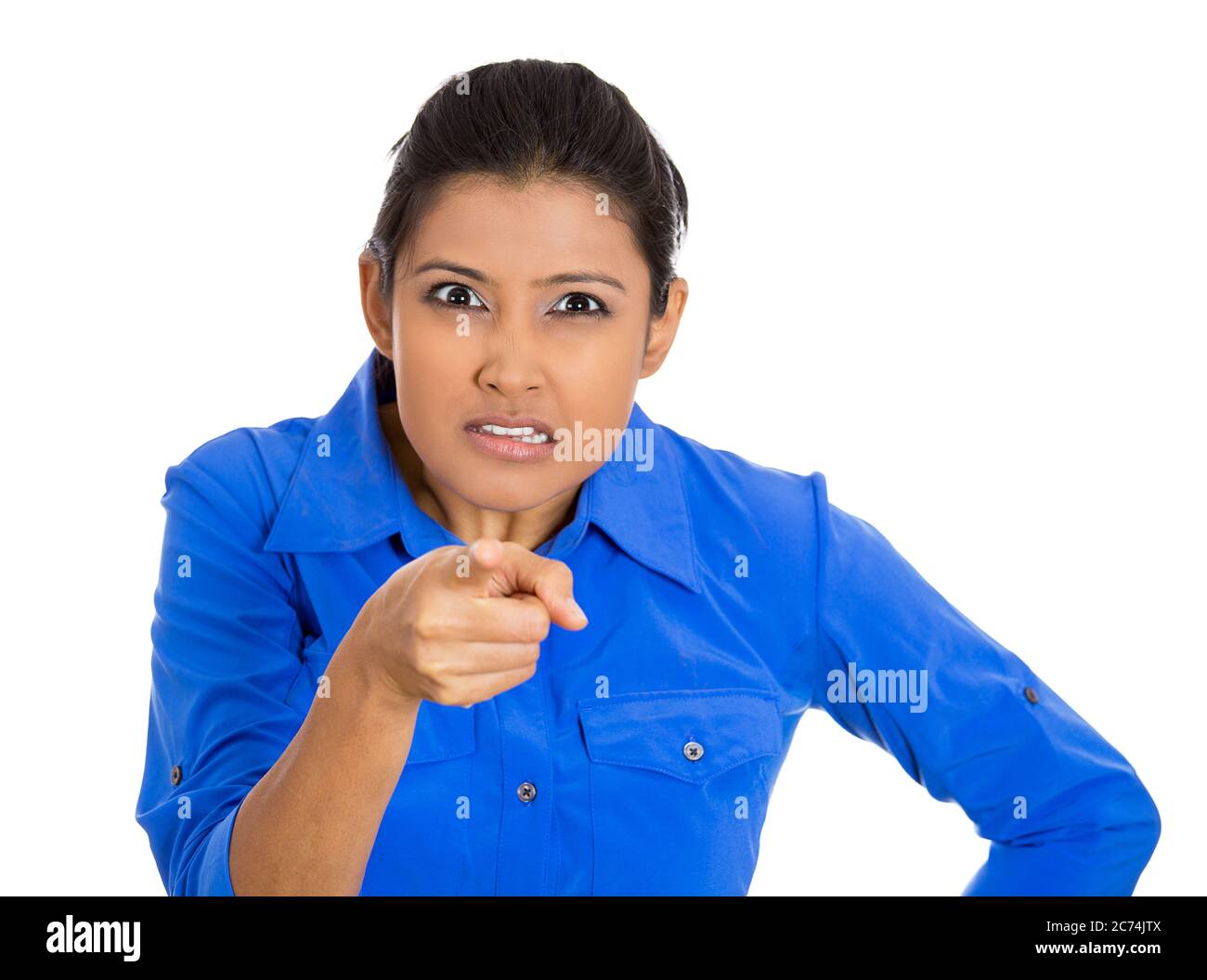 Portrait of young unhappy, serious woman pointing at someone finger isolated on white background Stock Photo