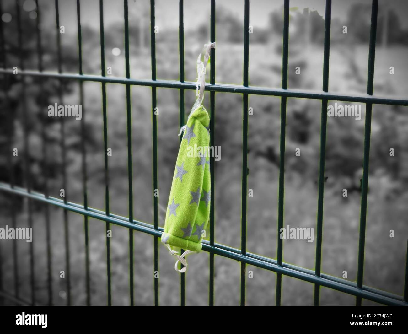used face mask at a fence, Color Pop Effect, Germany, North Rhine-Westphalia Stock Photo