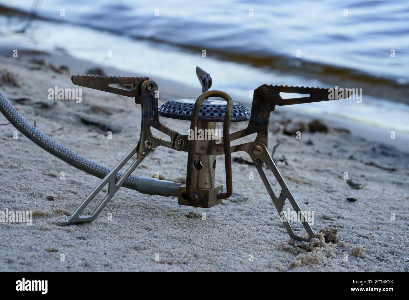 tourist gas burner stands on the sand Stock Photo