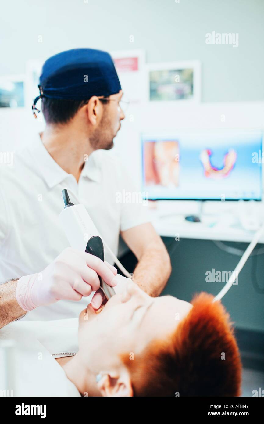 Dentist doctor while working in a chair with a patient treatment and
