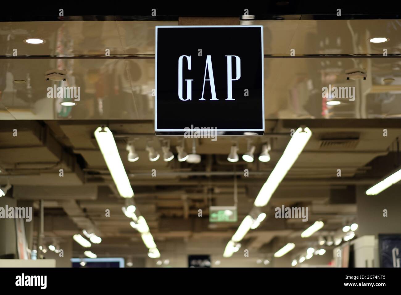 GAP's shop sign hanging in clothing store. Perspective bright white lamps  on the ceiling. An American fashion brand Stock Photo - Alamy