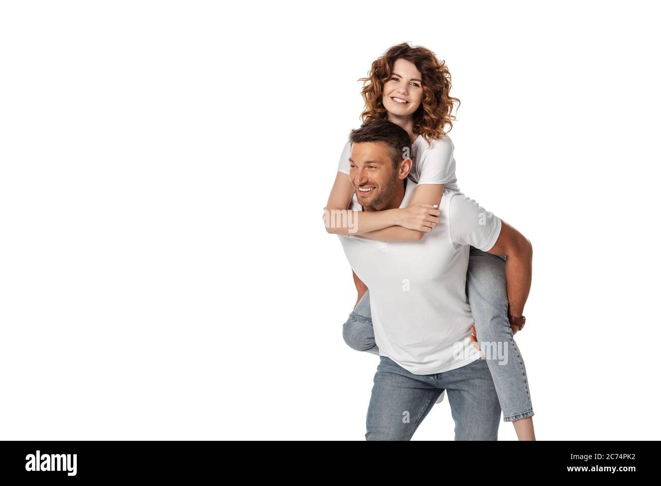 cheerful man piggybacking curly wife isolated on white Stock Photo