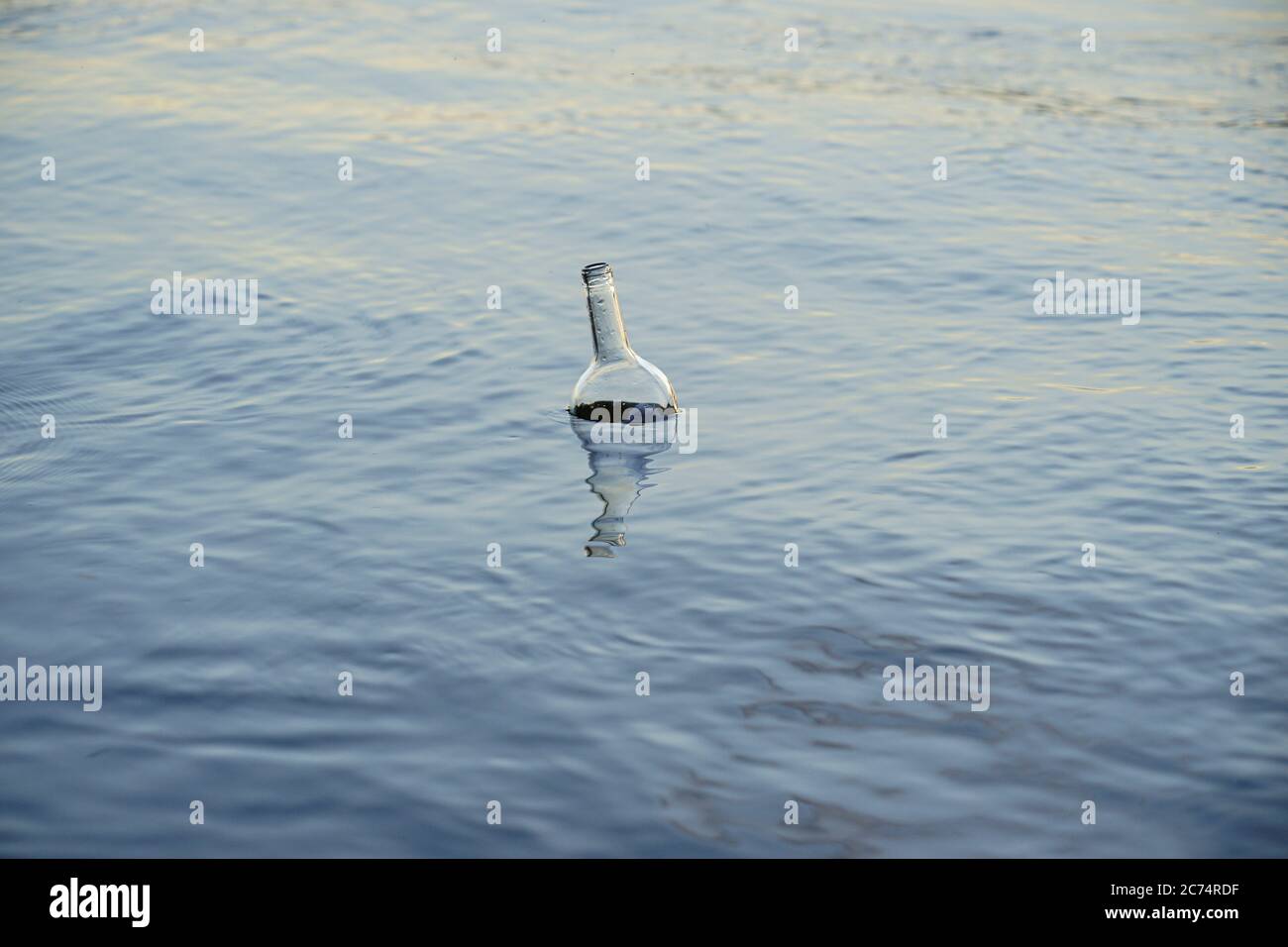 glass bottle floats adrift in water Stock Photo Alamy