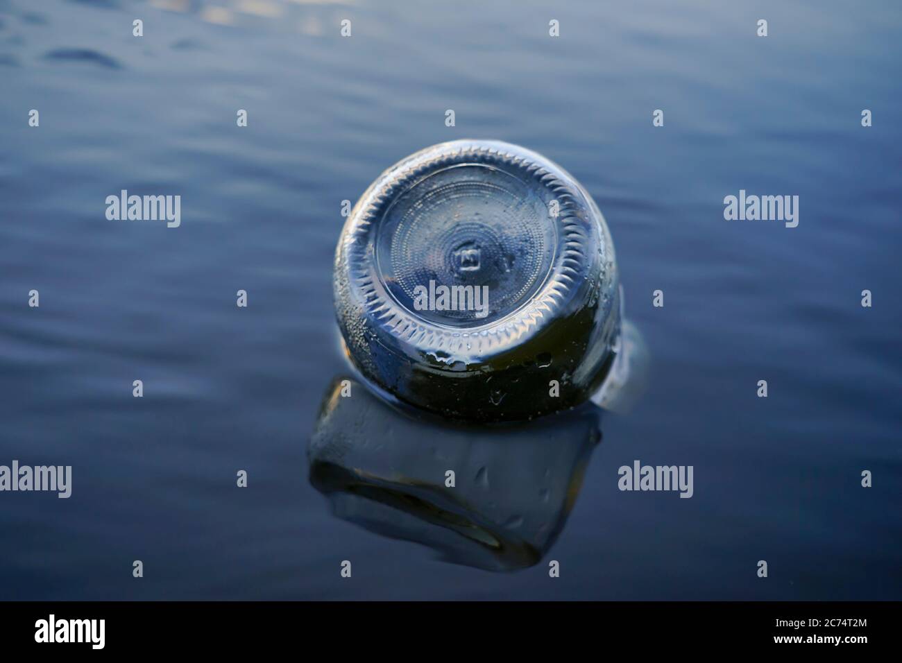 glass bottle floats adrift in water Stock Photo Alamy