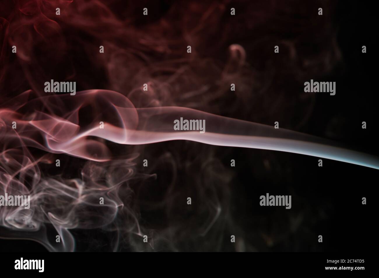 Abstract smoke swirls red color on black background. Elegant colorful curves wallpaper. Flow of cloud form smoke Stock Photo