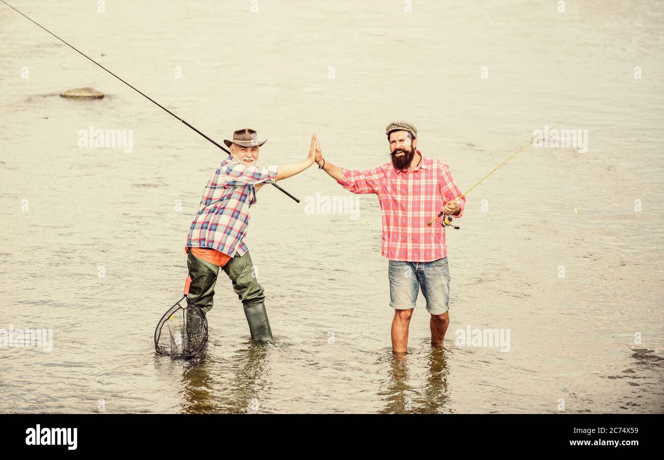 two in water. Big game fishing. friendship. father and son fishing. Poaching. two happy