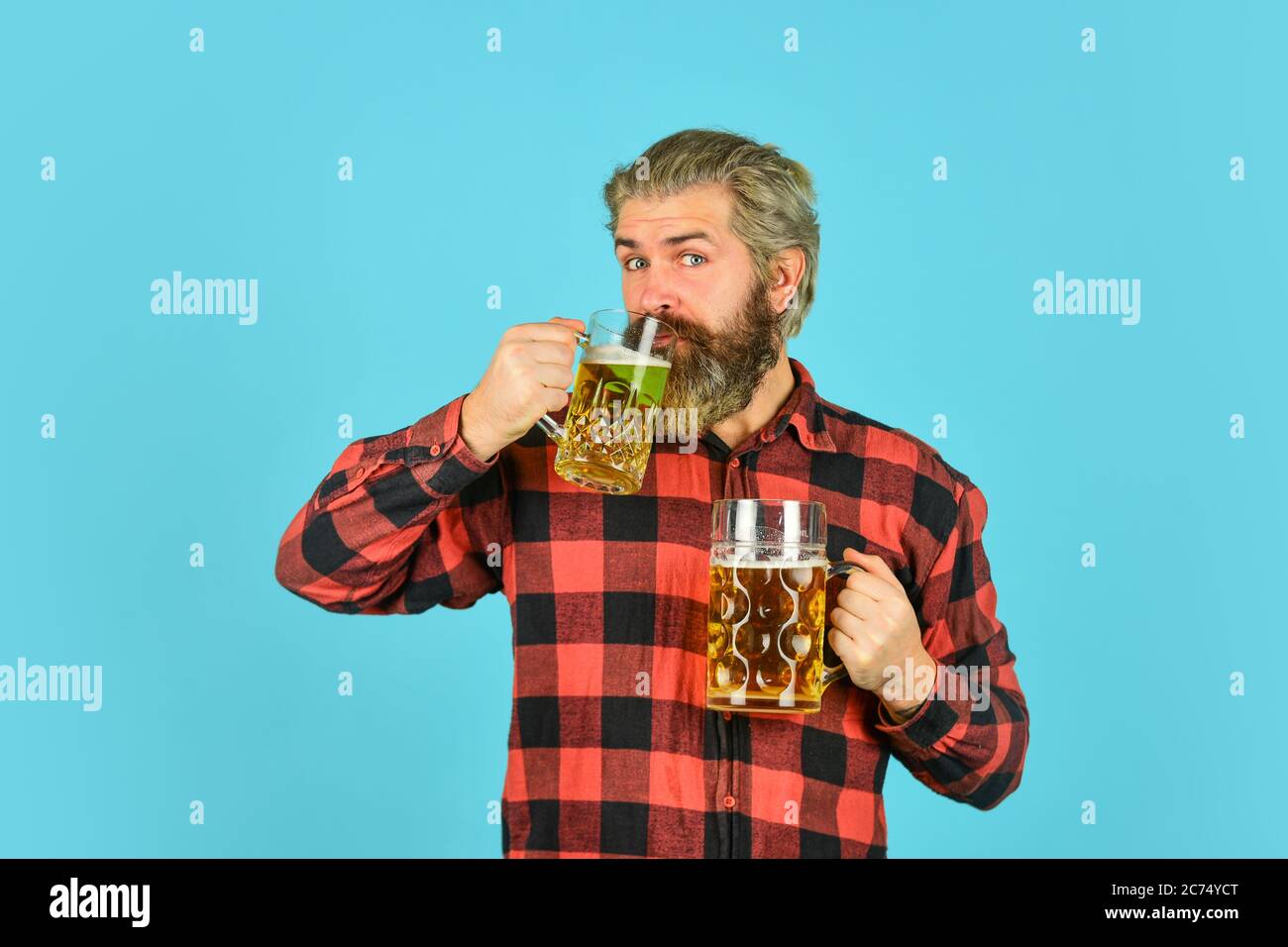 i like the taste. Man hold glass of beer. hipster at bar counter. having fun watching football. Brutal bearded male drinks beer from glass. Beer pub. Stylish bartender or barman in bar. recreation. Stock Photo