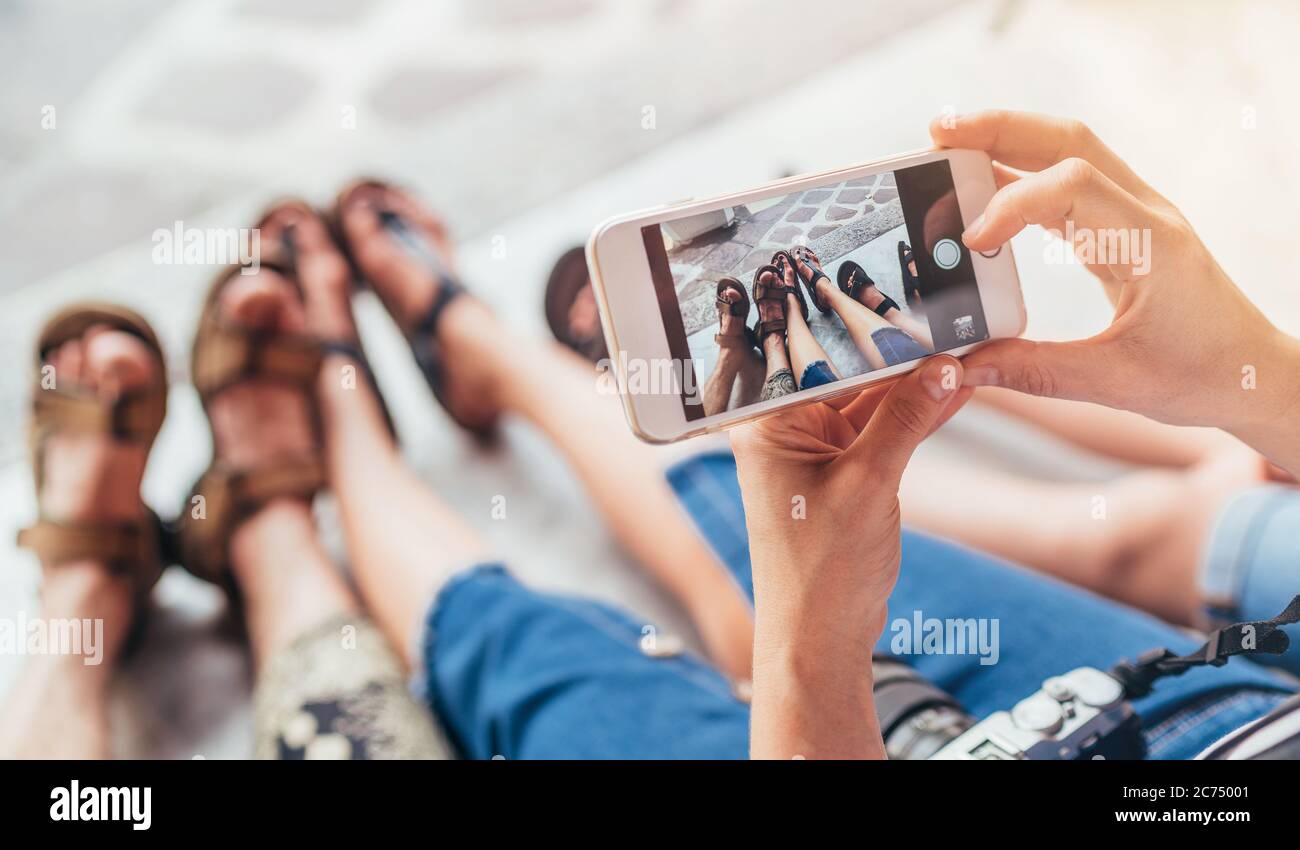 Tourist family takes picture their tired legs after sightseeing walking tour Stock Photo