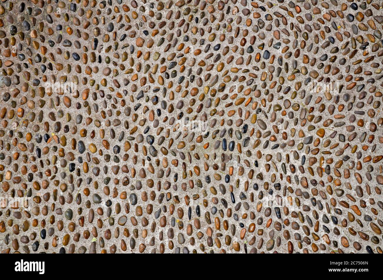 Background from multi-colored pebbles in cement (concrete) Stock Photo