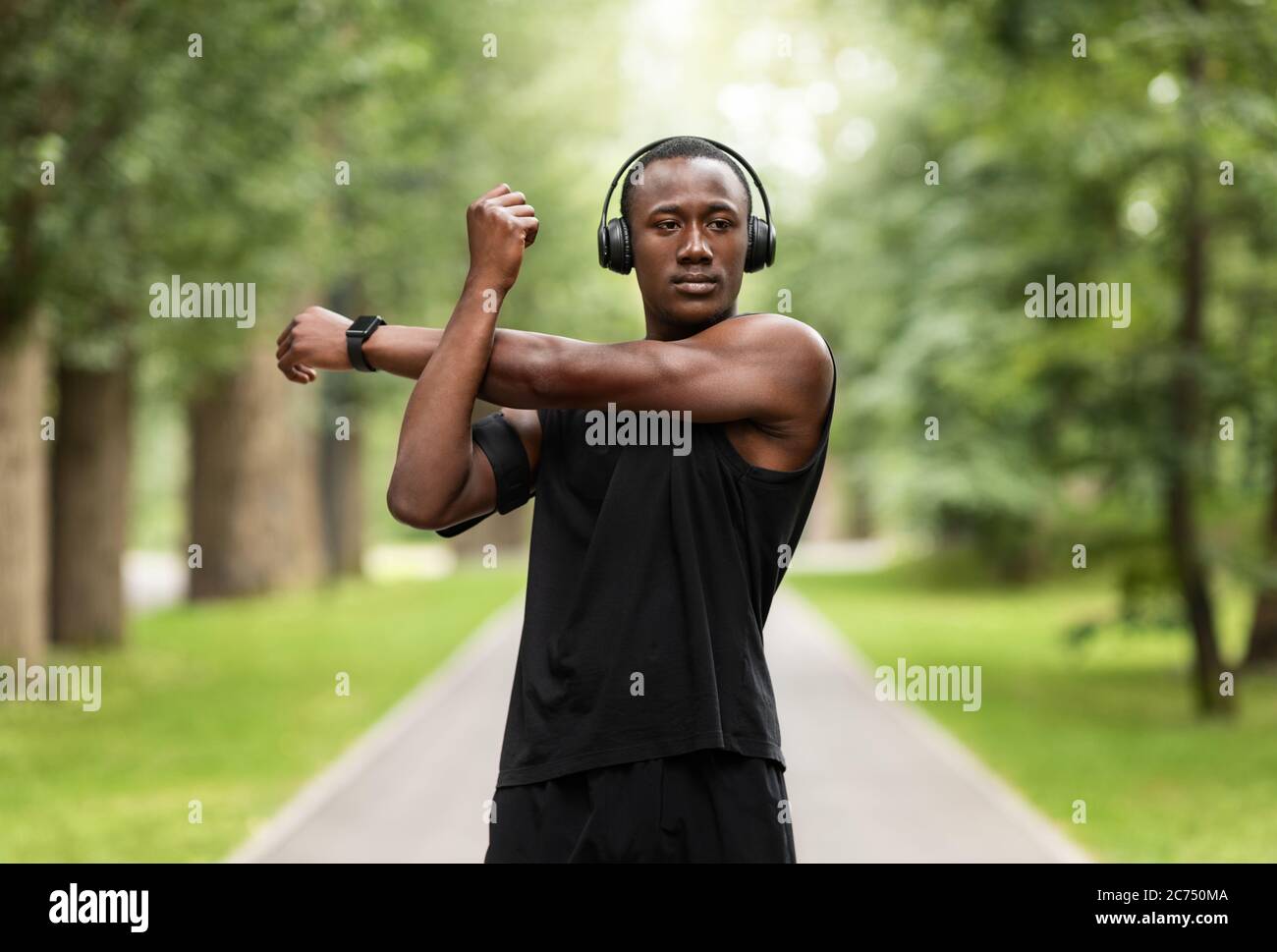 Runner man stretching arms hi-res stock photography and images - Alamy