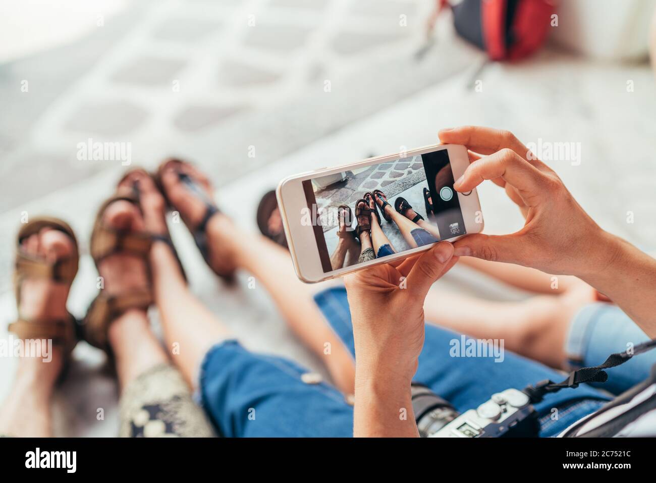 Tourist family takes picture their tired legs after sightseeing walking tour Stock Photo