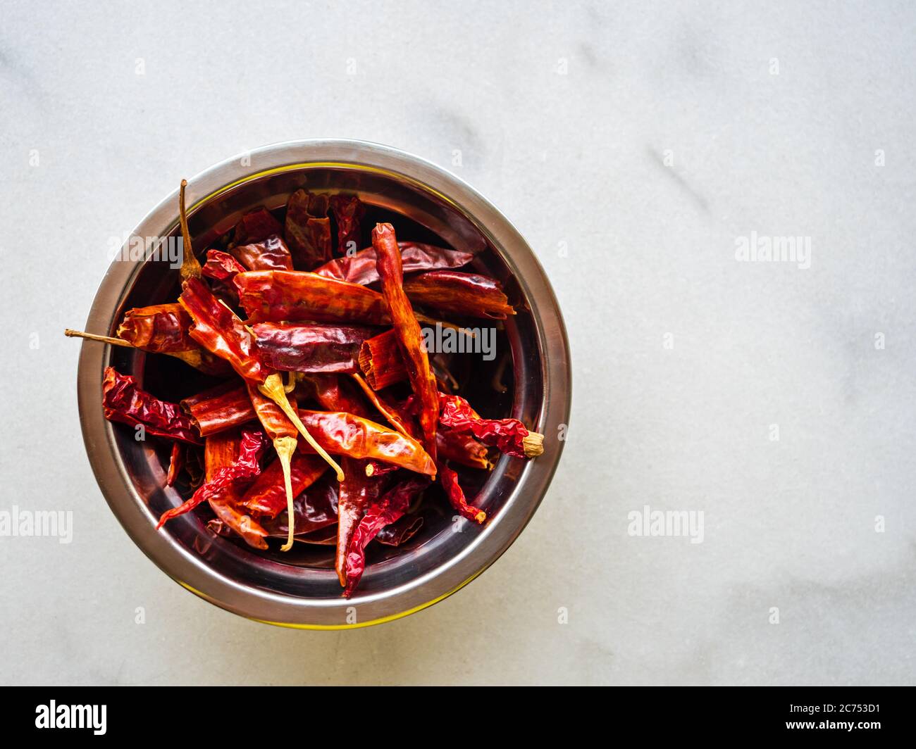 Close up of dried chillies /chilli peppers on off-white background with copy space Stock Photo