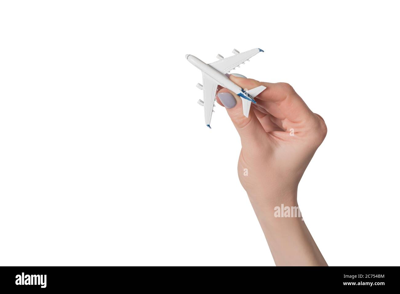 Passenger plane in female hand isolate on white background. Concept of safe flights. Stock Photo