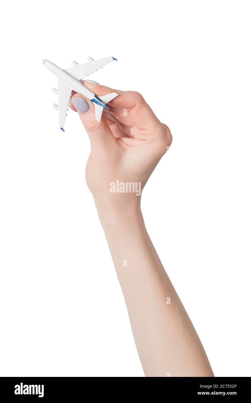 Passenger plane in female hand isolate on white background. Concept of safe flights. Stock Photo