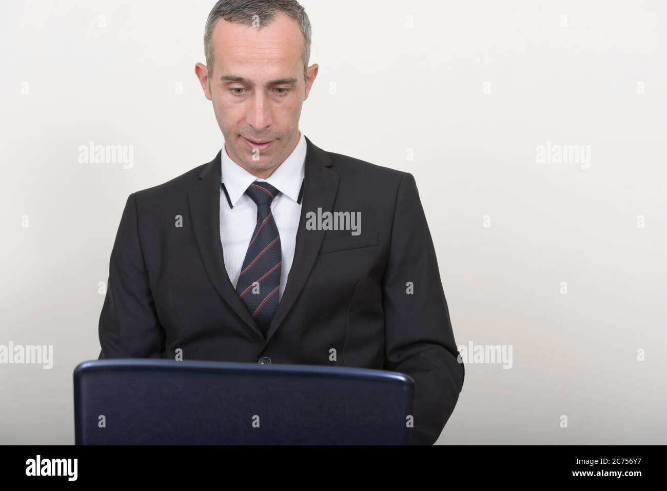 Portrait of mature handsome businessman in suit Stock Photo - Alamy