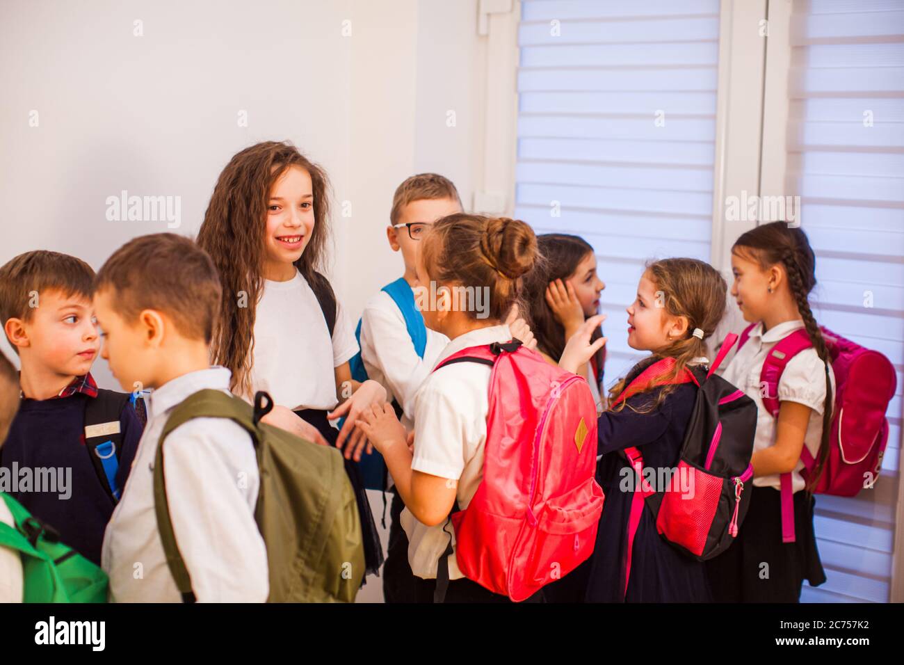 The little pupils are waiting in the school hallway Stock Photo Alamy