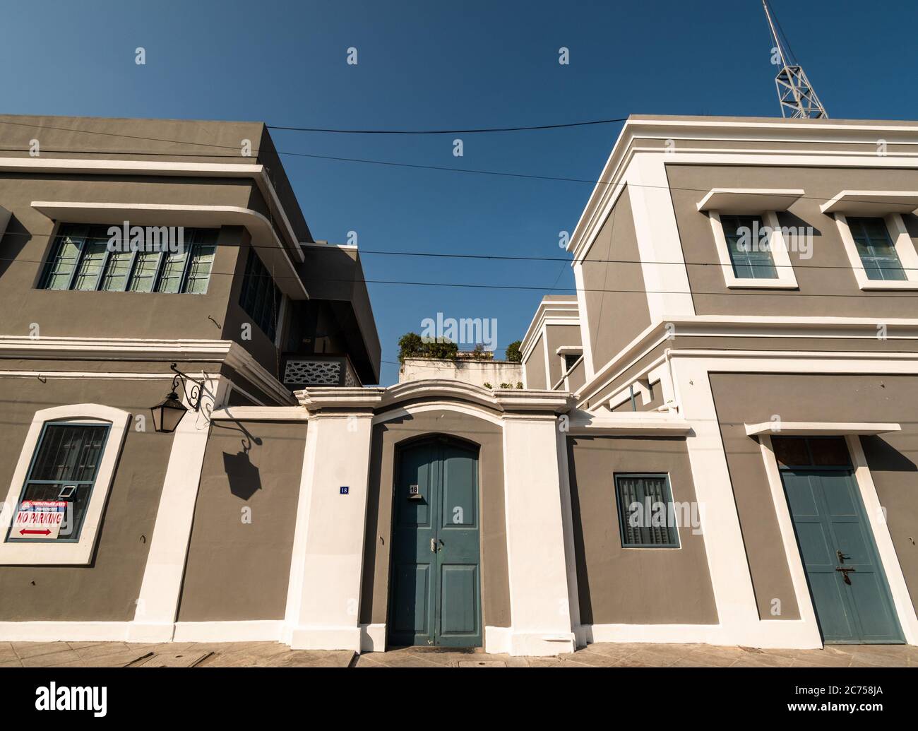 Pondicherry, India - February 2020: Beautiful French architecture of a house painted grey and white and pale blue doors in the old quarter of Pondiche Stock Photo