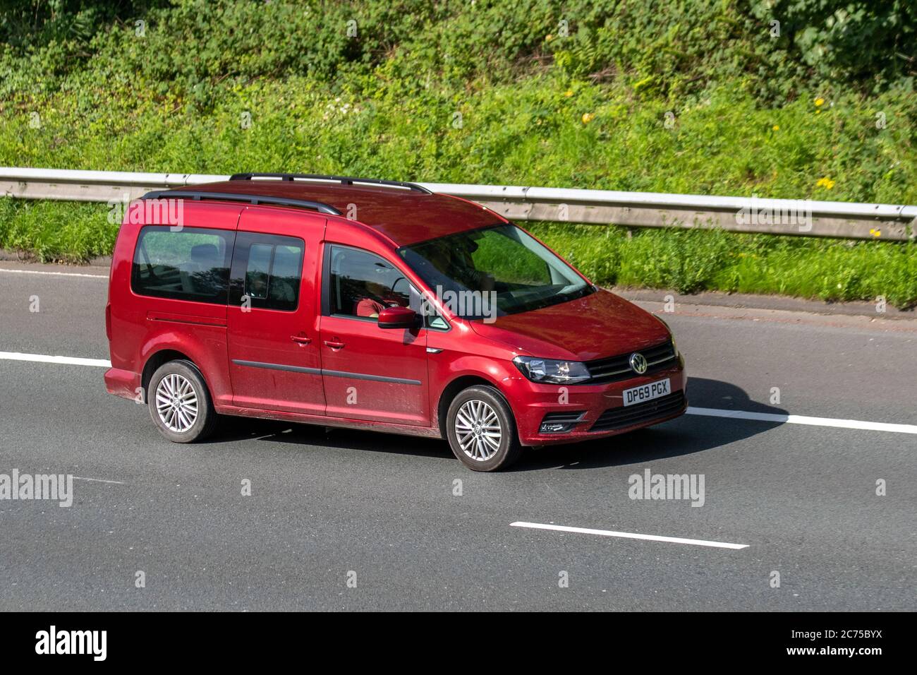 2020 red VW Volkswagen Caddy Maxi C20 Life TDI S; Vehicular traffic moving vehicles, cars driving vehicle on UK roads, motors, motoring on the M6 motorway highway network. Stock Photo