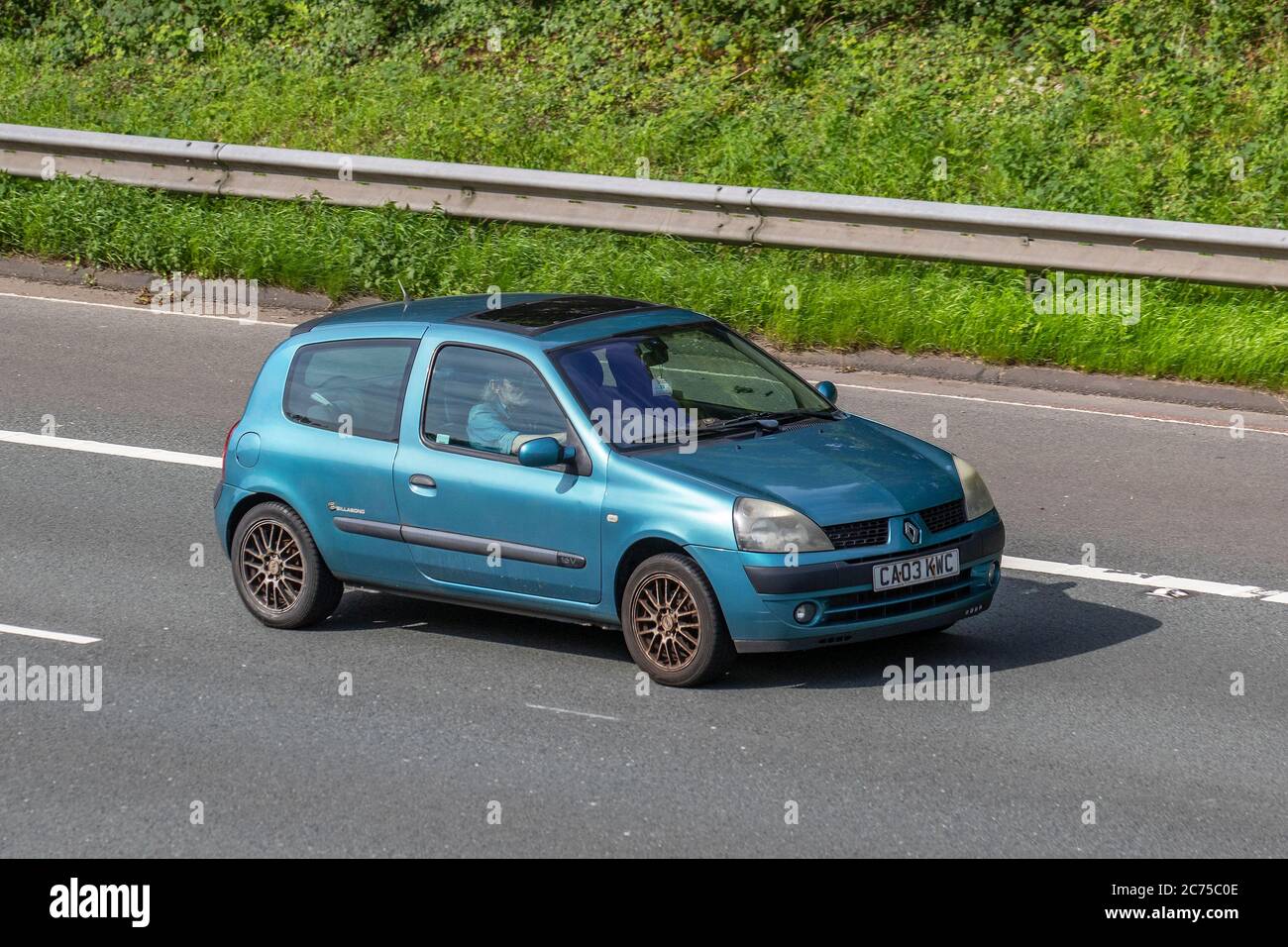 2003 (03) blue Renault Clio Dynam Billabong 16V; Vehicular traffic moving  vehicles, cars driving vehicle on UK roads, motors, motoring on the M6  motorway highway network Stock Photo - Alamy