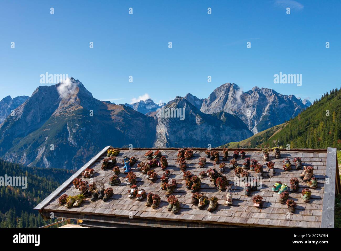 Plumsjochhütte, Karwendel mountains, Tirol, Austria. Roof covered in shoes used as plant pots Stock Photo