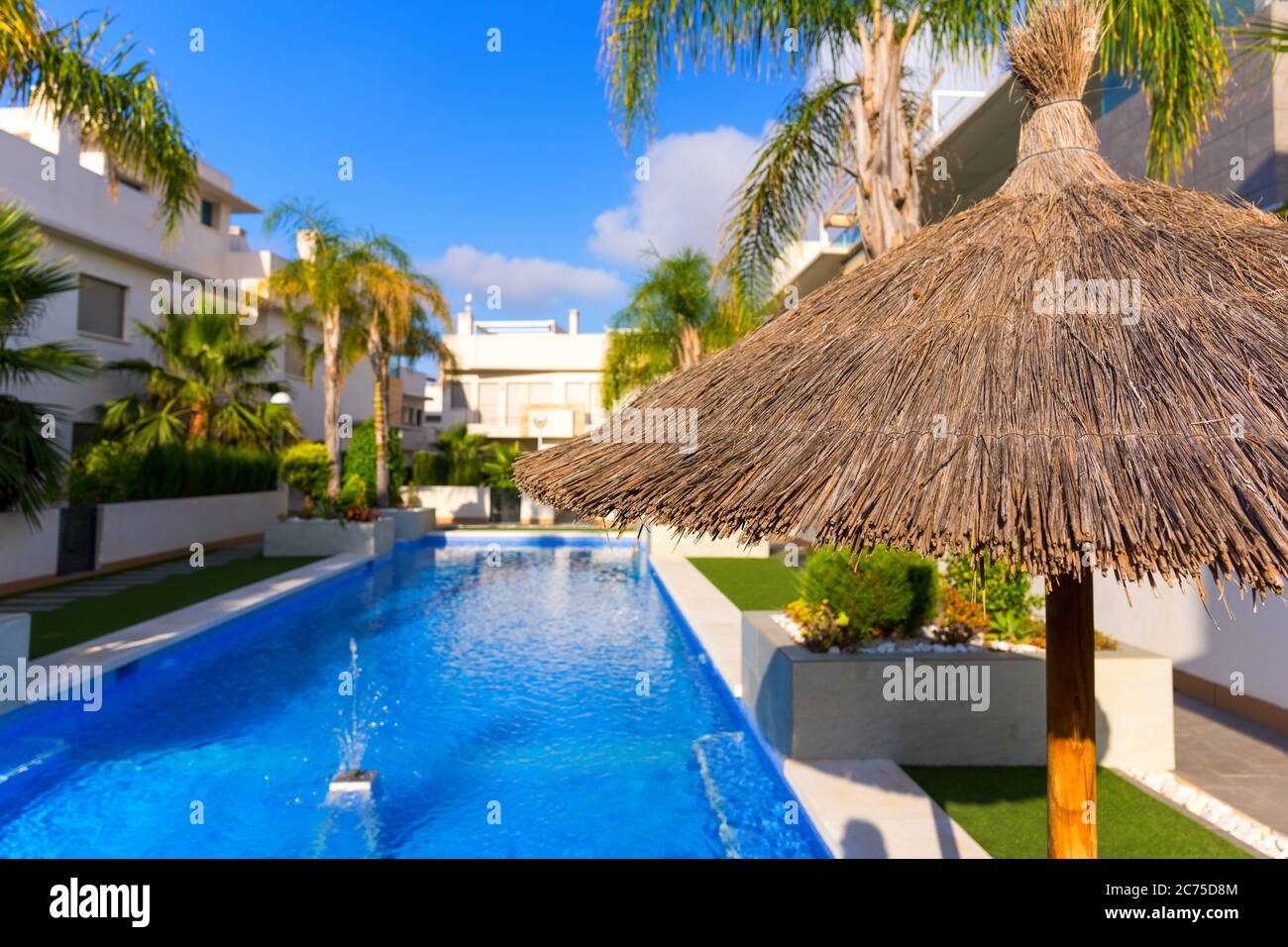 Pool in a condominium with blue water on a sunny day. Stock Photo