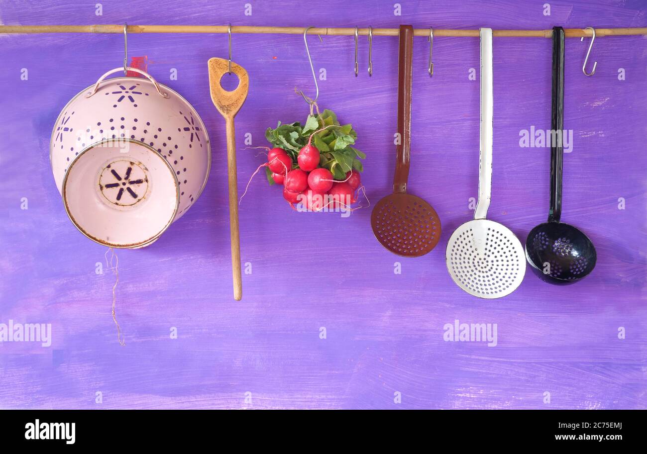 hanging vintage kitchen utensils and a bunch of radish, cooking concept,copy space Stock Photo