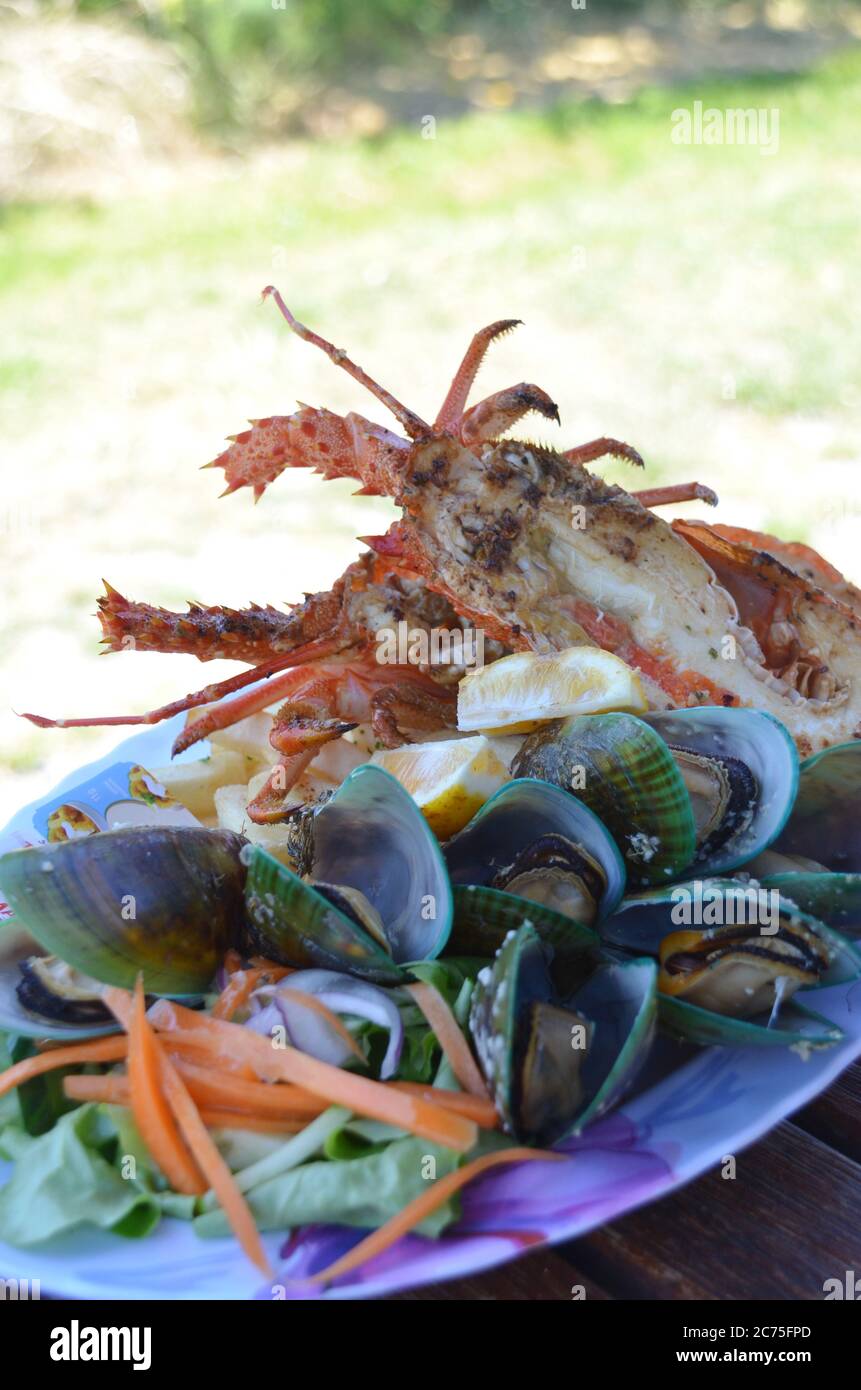 Kaikoura grilled lobster and mussel freshly caught by Maori people at New Zealand. Stock Photo
