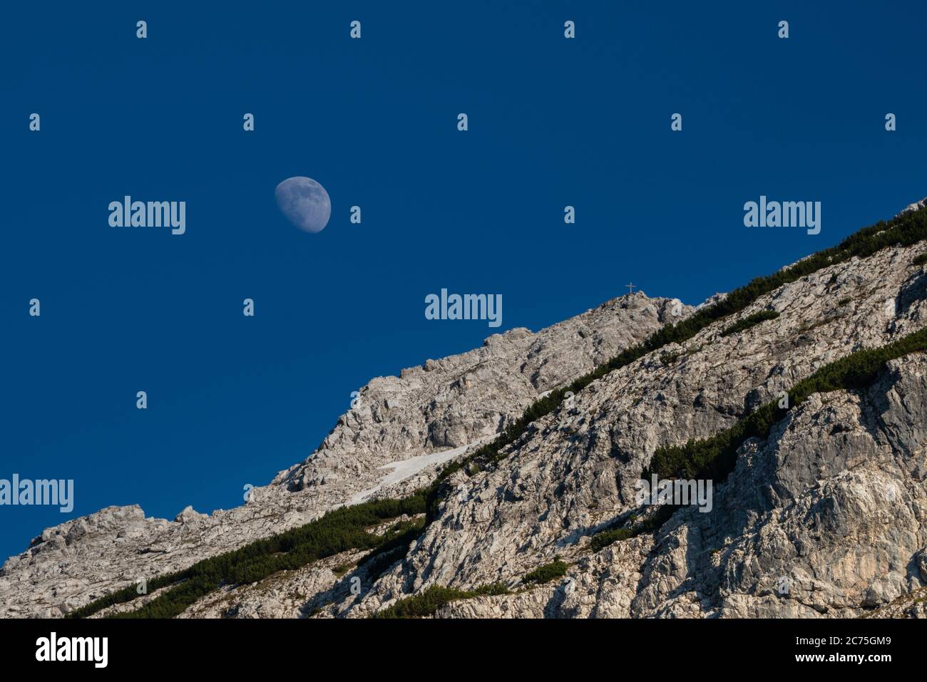 Moon rising over the Austrian Alps Stock Photo