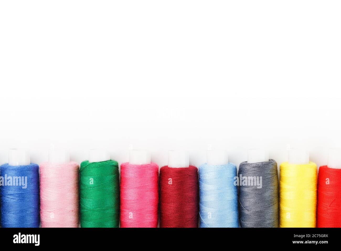 Colorful cotton craft sewing threads multicolored in a row isolated on ...