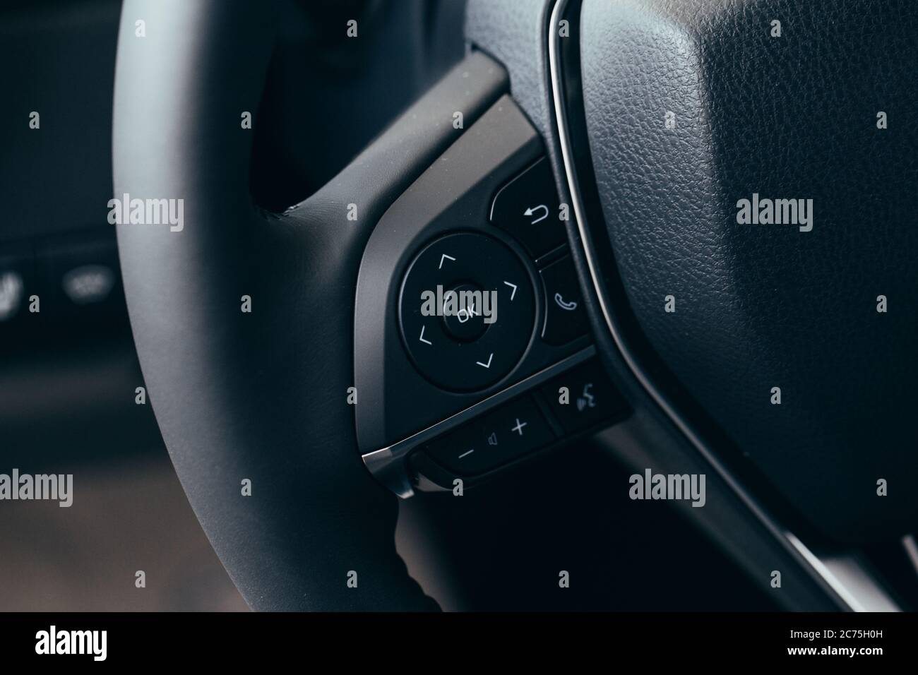 close up Modern black steering wheel with multifunction buttons