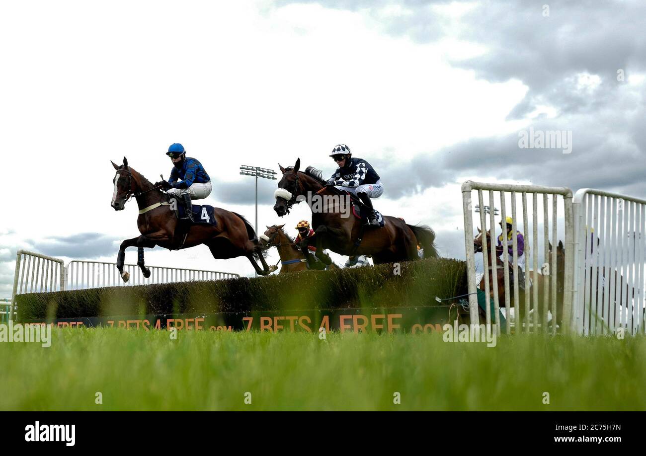 Fleur Du Seuil ridden by jockey Charlie Hammond (left) clears a hurdle whilst competing in the signsolutions.org Office & Interior Branding Mares' Novices' Hurdle at Southwell Racecourse. Stock Photo