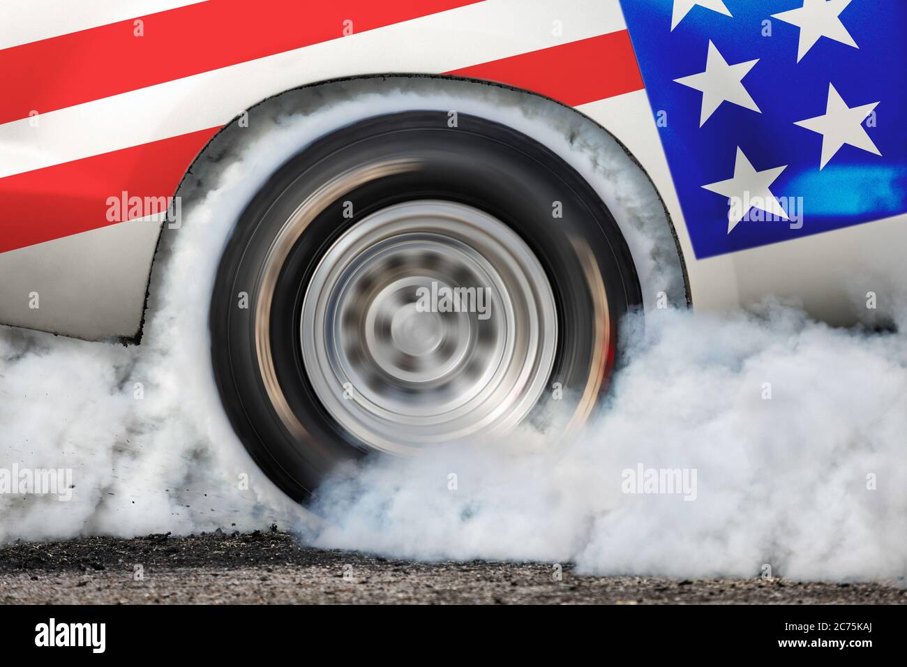 Drag racing car burns rubber off its tires in preparation for the race ...