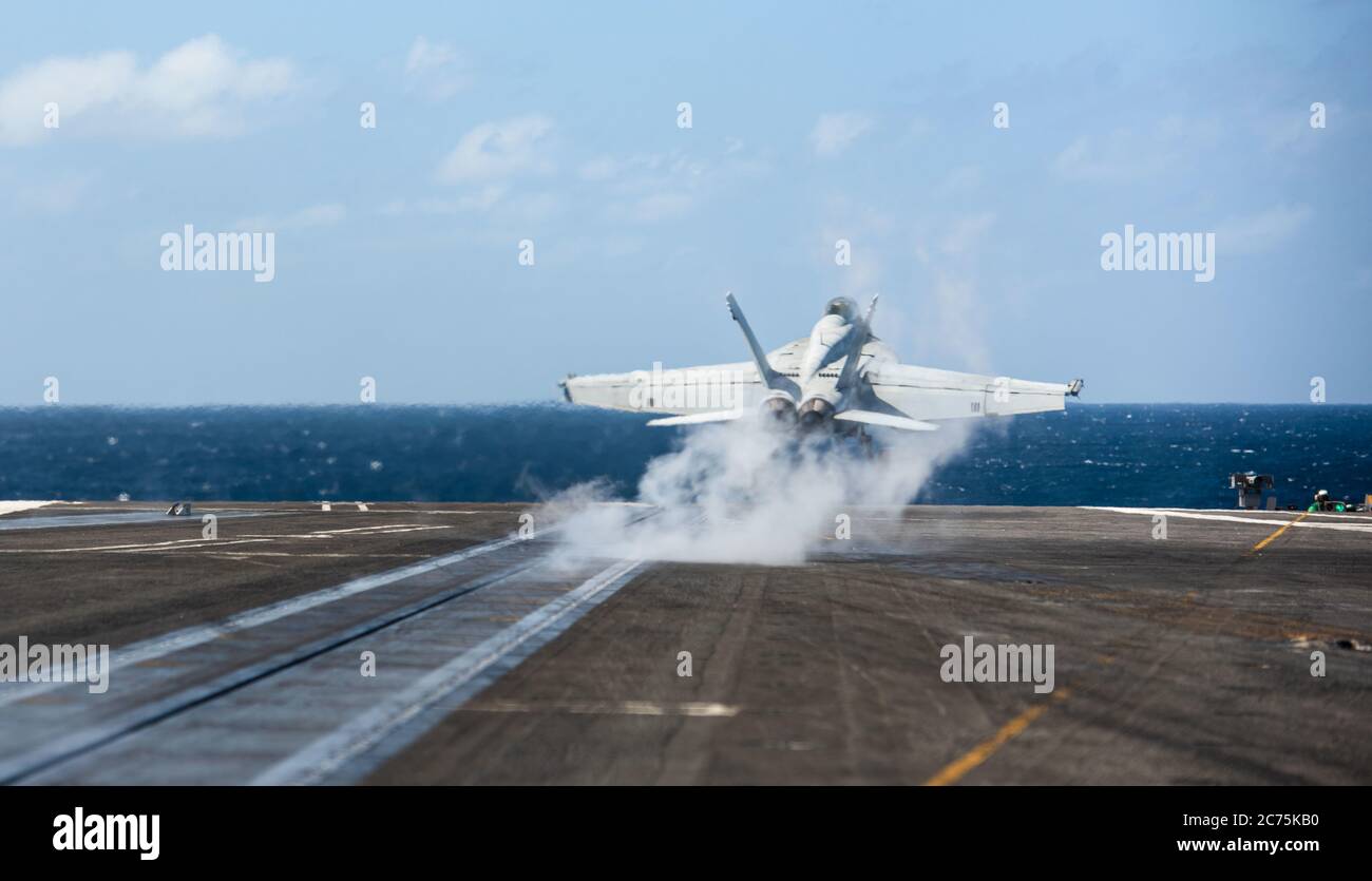 A U.S. Navy F/A-18E Super Hornet fighter aircraft, from the Diamondbacks of Strike Fighter Squadron 102, takes off from the flight deck of the Nimitz-class aircraft carrier USS Ronald Reagan during operations July 13, 2020 in the Indian Ocean. Stock Photo