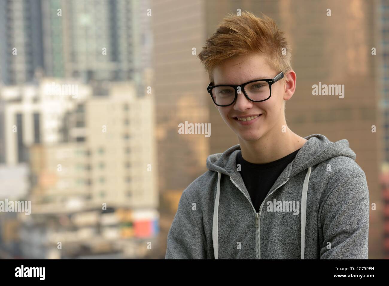Young handsome teenage boy against view of the city outdoors Stock ...