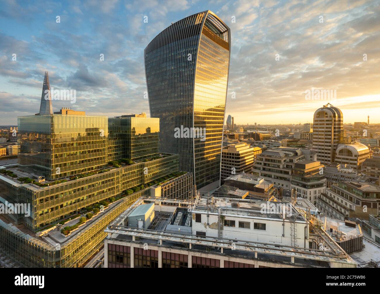 The iconic 'Walkie Talkie' (20 Fenchurch Street) skyscraper in Central London glowing in the golden light of a beautiful summer sunset. Stock Photo