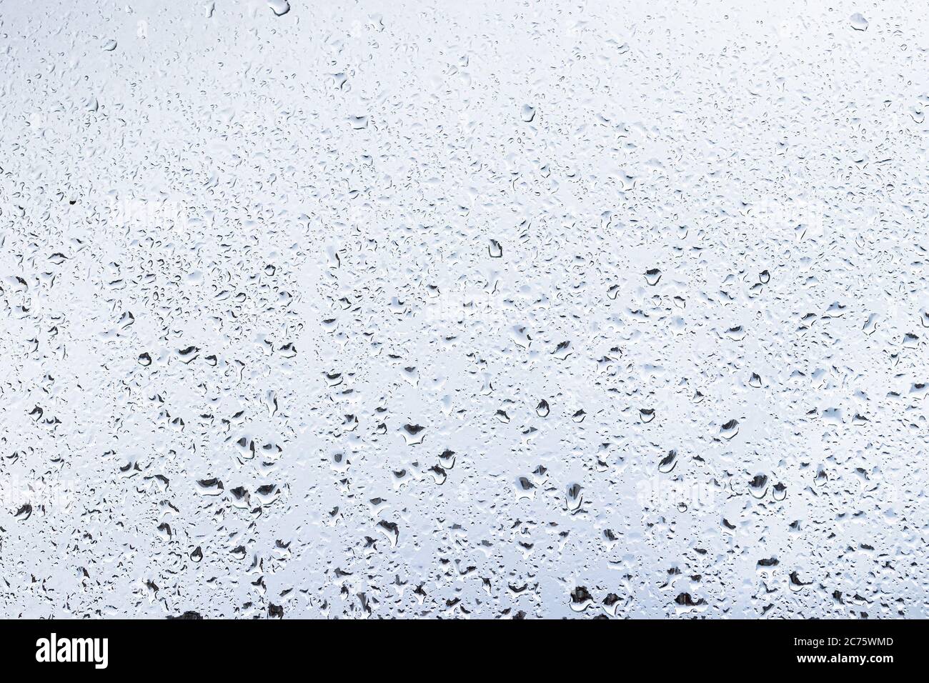 Rain drops on window glasses surface with cloudy background . Natural ...