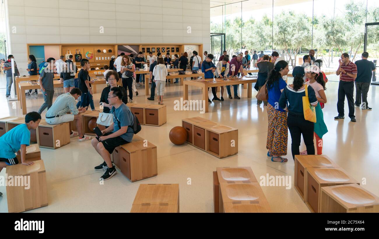 Cupertino, CA, USA - August 2019: Apple Store in Cupertino with people examining Apple products, Apple Headquarters infinite loop Stock Photo