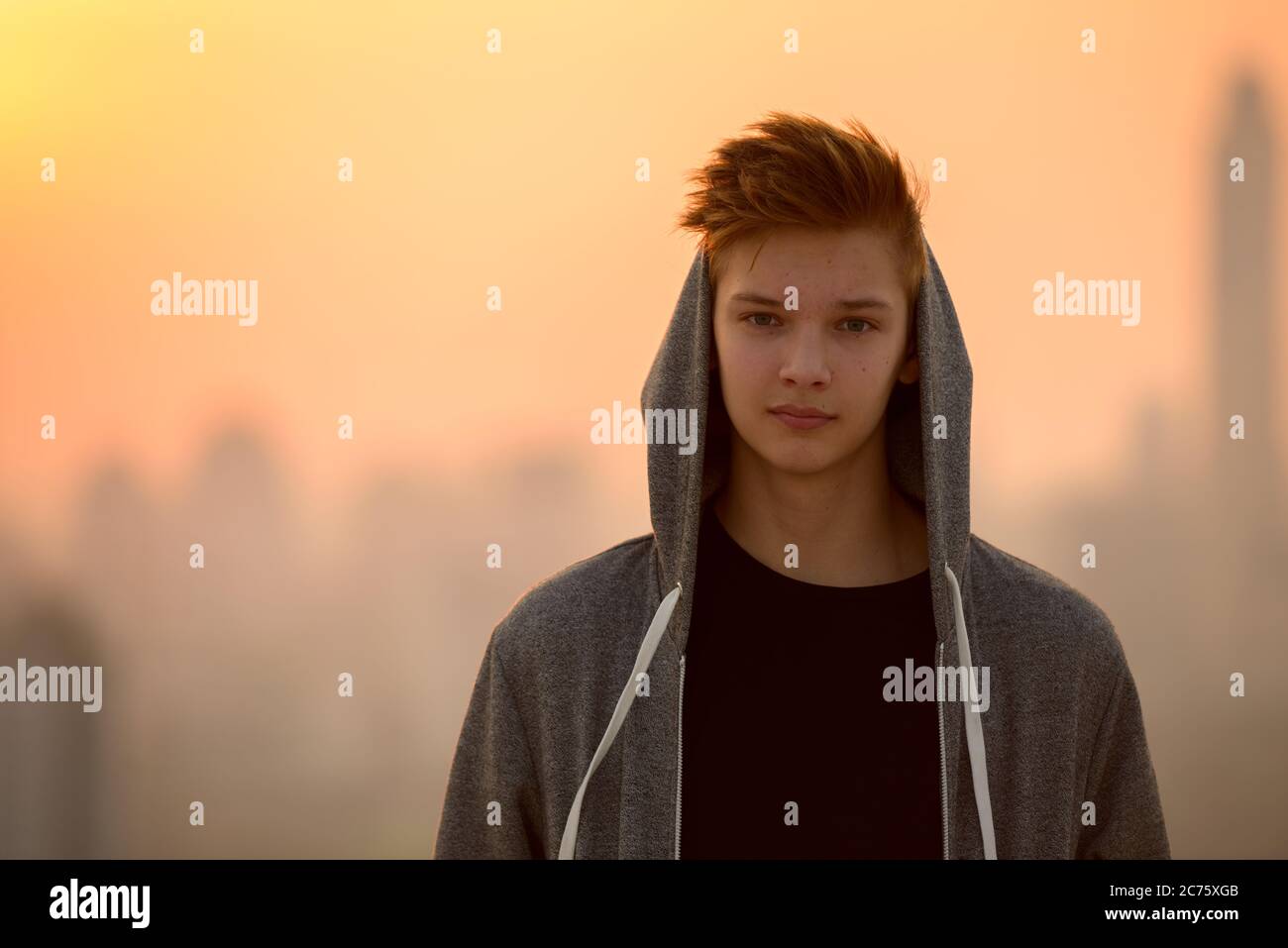 Young handsome teenage boy against view of the city outdoors Stock ...