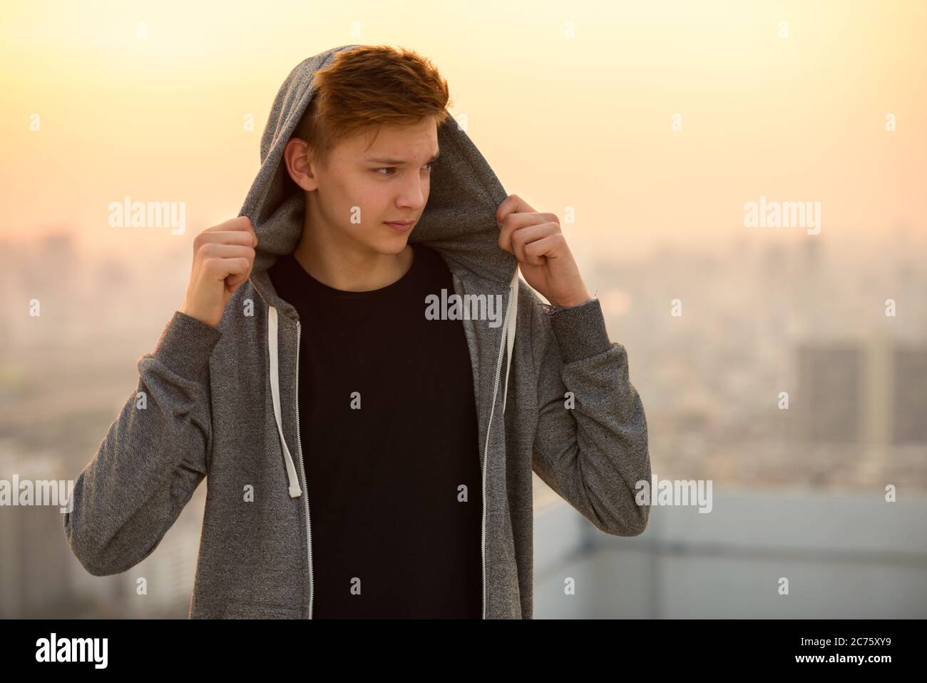 Young handsome teenage boy against view of the city outdoors Stock ...