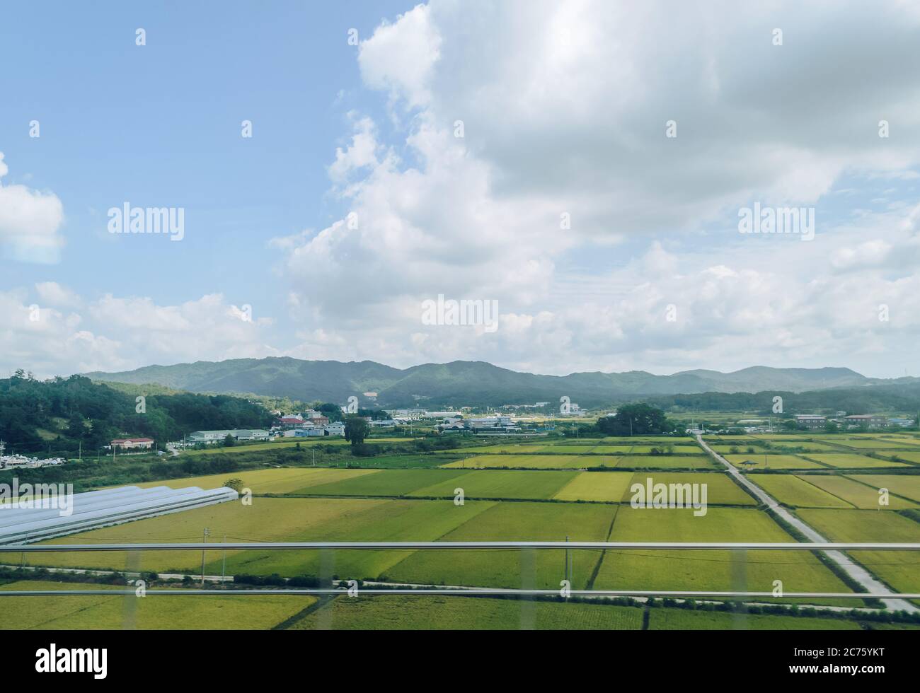 rural  village of south korea with crops mountains and greenhouses on hot cloudy day Stock Photo