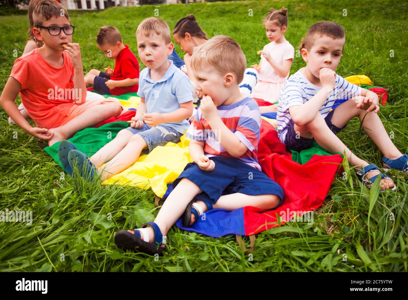 The cute kids have a snack in the park Stock Photo