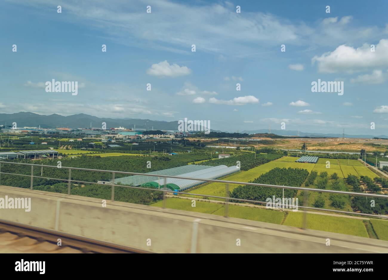 view of greenhouses and agricultural fields with plants and orchards in rural area of South Korea Stock Photo
