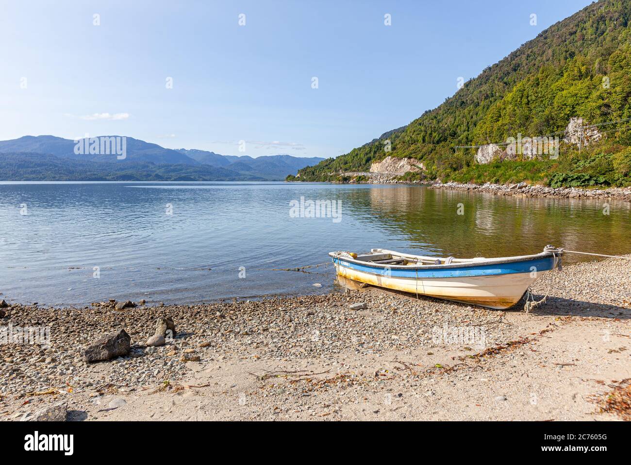 Boat anchored on the beach of the fjord of Puyuhuapi, Patagonia, Chile. Pacific Ocean Stock Photo