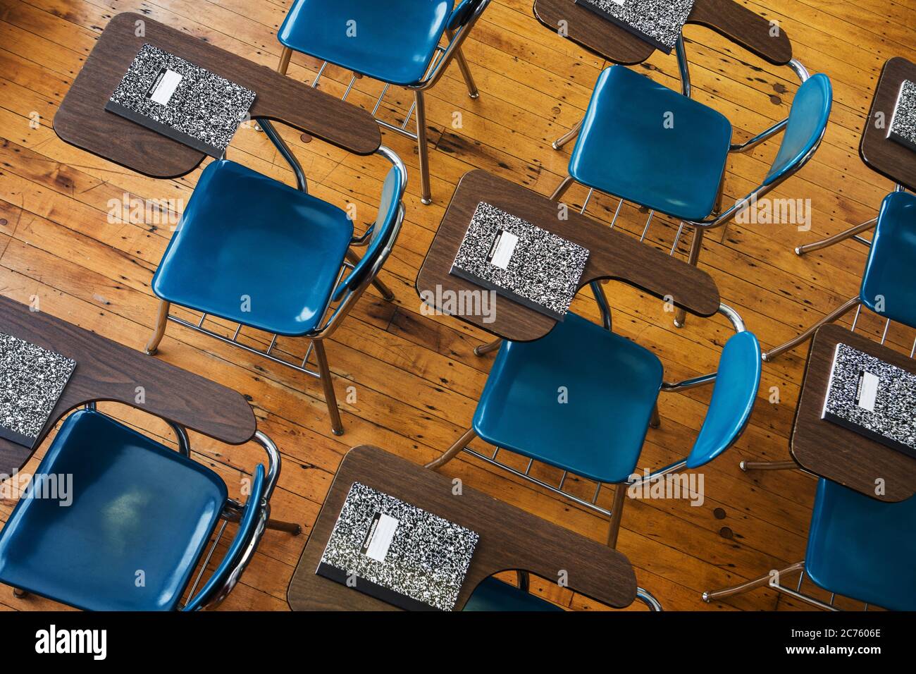 A group of school desks with notebooks on them. Stock Photo