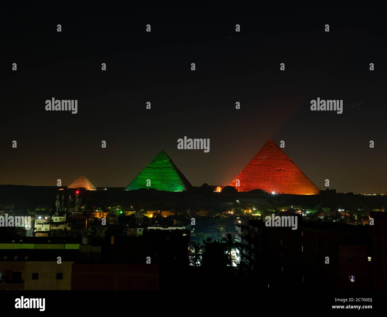 pyramids with skyline of giza at night with illustration lightshow ...
