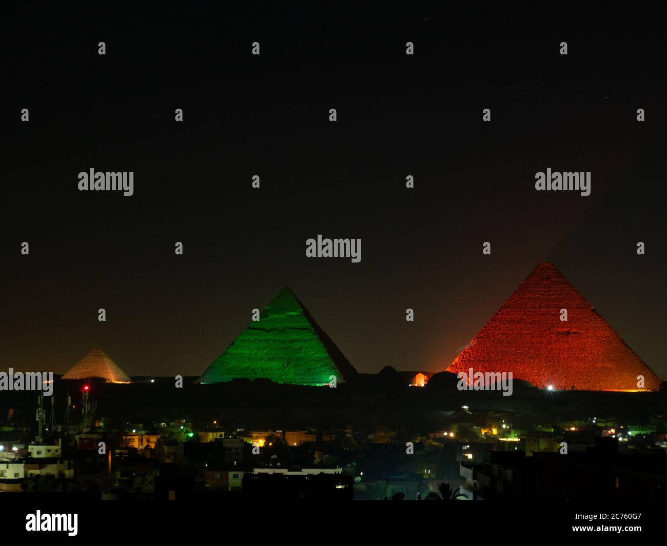 pyramids with skyline of giza at night with illustration lightshow ...