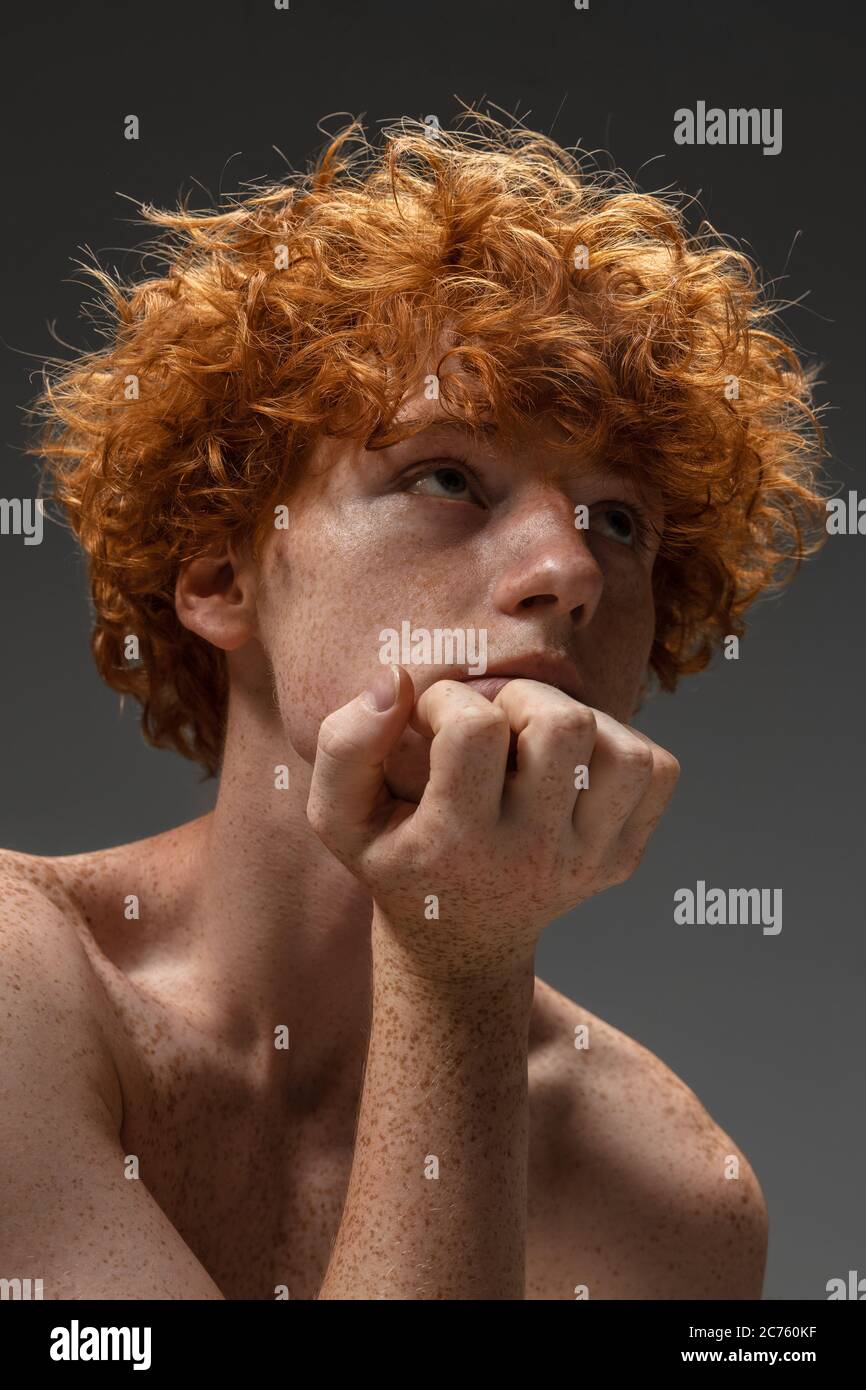 Dreamful. Fashion portrait of beautiful redhead man isolated on 