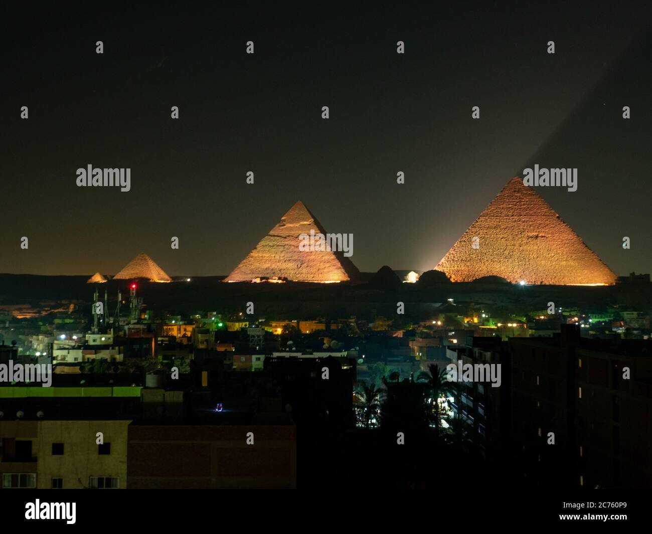 pyramids with skyline of giza at night with illustration lightshow ...