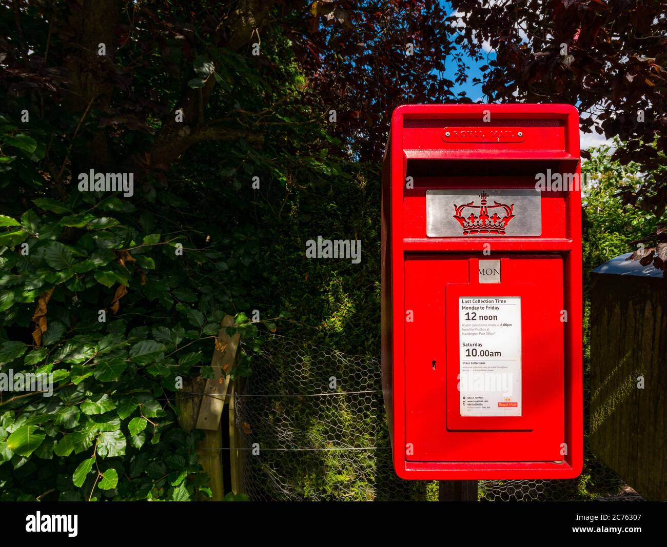 Royal Mail bright red village postbox, Gifford, East Lothian, Scotland, UK Stock Photo
