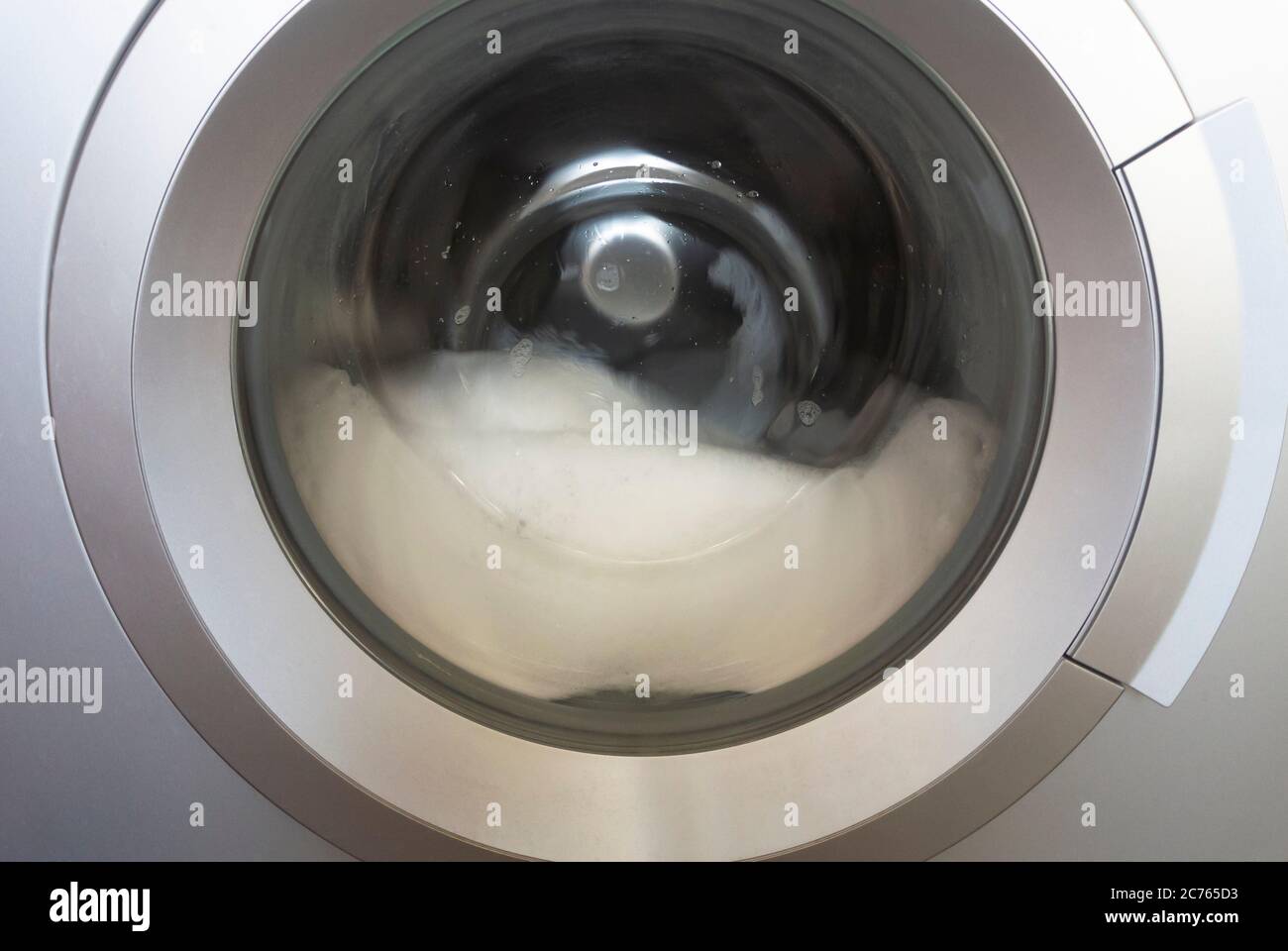 The drum of the washing machine with foam Stock Photo Alamy
